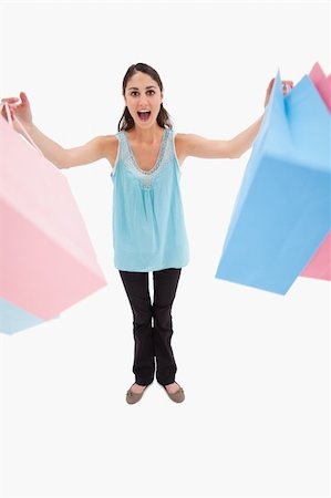 simsearch:400-06092781,k - Portrait of a woman holding shopping bags against a white background Photographie de stock - Aubaine LD & Abonnement, Code: 400-05898447