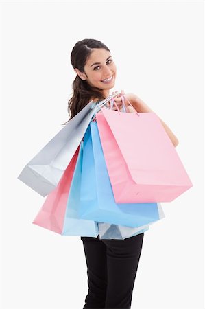 simsearch:400-06092781,k - Portrait of a happy woman posing with shopping bags against a white background Photographie de stock - Aubaine LD & Abonnement, Code: 400-05898452