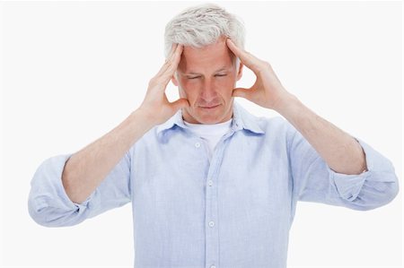 simsearch:400-04978521,k - Tired man having a headache against a white background Stock Photo - Budget Royalty-Free & Subscription, Code: 400-05898514