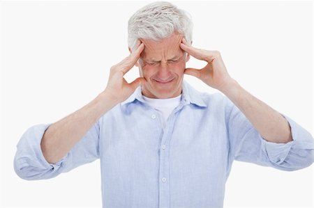 simsearch:400-04978521,k - Exhausted man having a strong headache against a white background Stock Photo - Budget Royalty-Free & Subscription, Code: 400-05898516