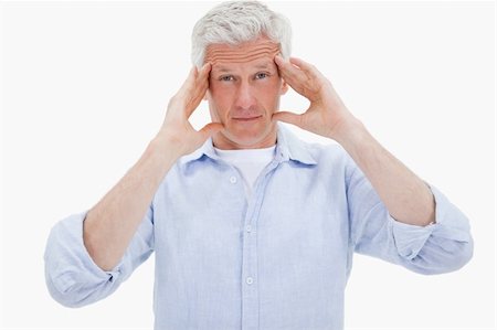 simsearch:400-04978521,k - Mature man having a headache against a white background Stock Photo - Budget Royalty-Free & Subscription, Code: 400-05898513