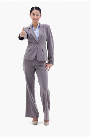 simsearch:400-05898224,k - Portrait of a happy businesswoman posing with the thumb up against a white background Foto de stock - Royalty-Free Super Valor e Assinatura, Número: 400-05898579