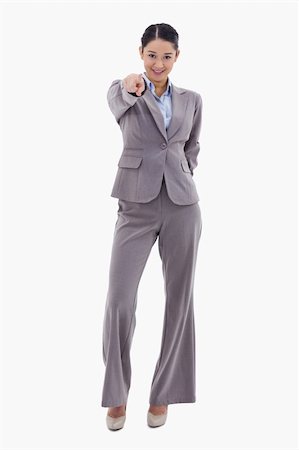 simsearch:400-05898224,k - Portrait of a young brunette businesswoman pointing at the viewer against a white background Foto de stock - Royalty-Free Super Valor e Assinatura, Número: 400-05898584