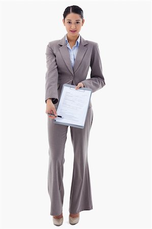 simsearch:400-06633122,k - Portrait of a smiling businesswoman showing a contract against a white background Stock Photo - Budget Royalty-Free & Subscription, Code: 400-05898595