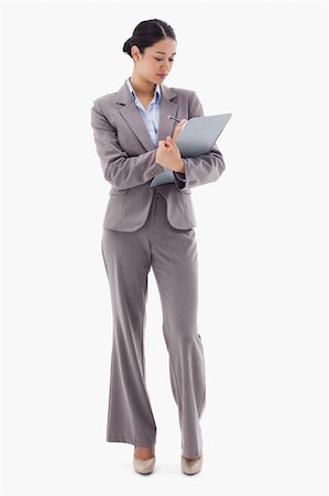 simsearch:400-06633122,k - Portrait of a businesswoman taking notes against a white background Stock Photo - Budget Royalty-Free & Subscription, Code: 400-05898591