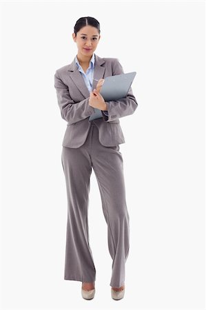 simsearch:400-06633122,k - Portrait of a brunette businesswoman taking notes against a white background Stock Photo - Budget Royalty-Free & Subscription, Code: 400-05898593
