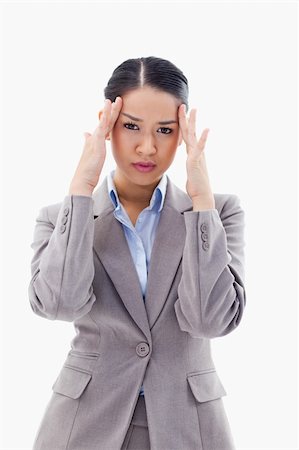 simsearch:6109-08395843,k - Portrait of a gorgeous businesswoman having a headache against a white background Stock Photo - Budget Royalty-Free & Subscription, Code: 400-05898606