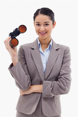 simsearch:400-04632747,k - Portrait of a businesswoman holding binoculars against a white background Fotografie stock - Microstock e Abbonamento, Codice: 400-05898635