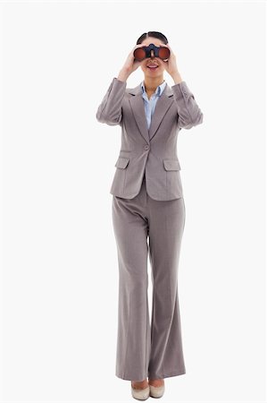 simsearch:400-04554899,k - Portrait of a businesswoman looking through binoculars against a white background Stock Photo - Budget Royalty-Free & Subscription, Code: 400-05898636