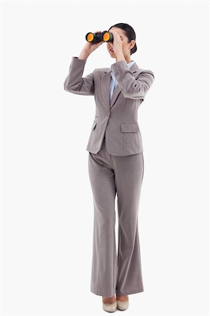 simsearch:400-04554899,k - Portrait of a brunette businesswoman looking through binoculars against a white background Stock Photo - Budget Royalty-Free & Subscription, Code: 400-05898637
