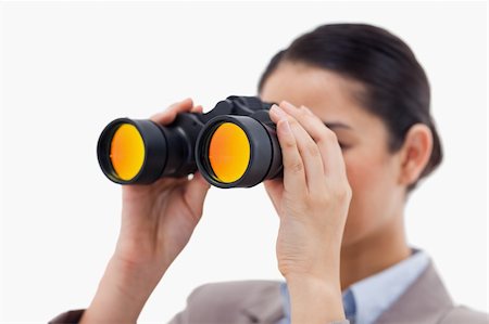 simsearch:400-04632747,k - Brunette businesswoman looking through binoculars against a white background Fotografie stock - Microstock e Abbonamento, Codice: 400-05898633
