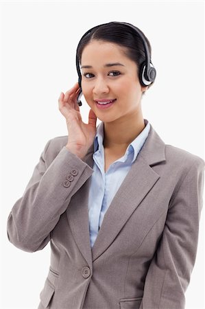 Portrait of a good looking operator posing with a headset against a white background Stock Photo - Budget Royalty-Free & Subscription, Code: 400-05898653