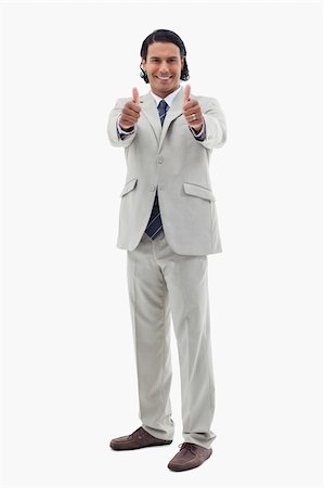 simsearch:400-06091141,k - Portrait of an office worker posing with the thumbs up against a white background Photographie de stock - Aubaine LD & Abonnement, Code: 400-05898667