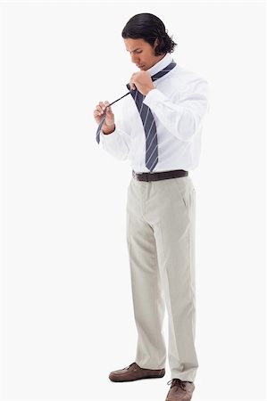 simsearch:400-04150475,k - Portrait of an office worker putting his tie against a white background Foto de stock - Super Valor sin royalties y Suscripción, Código: 400-05898672