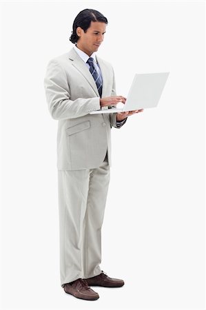 simsearch:6116-08915424,k - Portrait of a businessman using a notebook against a white background Foto de stock - Super Valor sin royalties y Suscripción, Código: 400-05898688