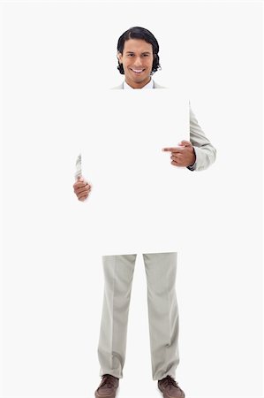 Businessman pointing at blank sign in his hands against a white background Stock Photo - Budget Royalty-Free & Subscription, Code: 400-05898696