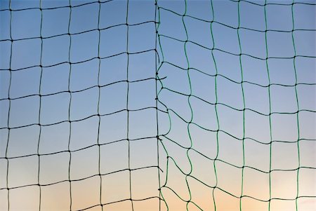 soccer stadium net - Broken sports net on blue and orange sky Stock Photo - Budget Royalty-Free & Subscription, Code: 400-05898898