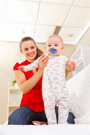 Smiling mother helping baby learn to walk Stock Photo - Budget Royalty-Free & Subscription, Code: 400-05899077
