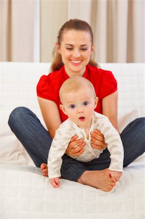 simsearch:400-05899075,k - Interested baby playing on mothers laps Fotografie stock - Microstock e Abbonamento, Codice: 400-05899083