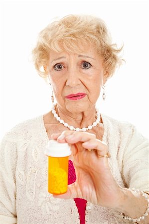 simsearch:400-04419056,k - Sad senior woman holding a bottle of pills.  White background. Foto de stock - Royalty-Free Super Valor e Assinatura, Número: 400-05899491