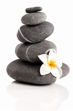 spa decoration - Stones pyramid with a plumeria flower, isolated on white background Stock Photo - Budget Royalty-Free & Subscription, Code: 400-05890005