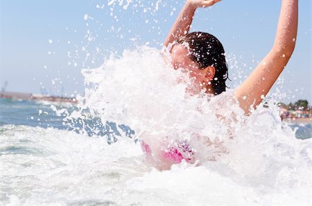 woman is playing with waves in sea Stock Photo - Budget Royalty-Free & Subscription, Code: 400-05890318