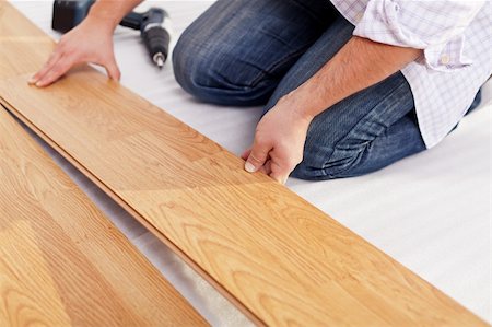 Installing laminate flooring fitting the next piece - focus on hand Stock Photo - Budget Royalty-Free & Subscription, Code: 400-05890743