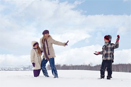 Kids and woman enjoy the snow having a snowball fight Stock Photo - Budget Royalty-Free & Subscription, Code: 400-05890763