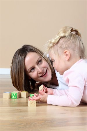 Mother and daughter playing with alphabet building blocks Stock Photo - Budget Royalty-Free & Subscription, Code: 400-05890868