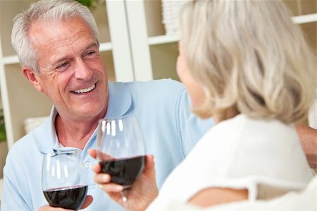 Happy senior man and woman couple sitting together at home smiling and drinking wine Stock Photo - Budget Royalty-Free & Subscription, Code: 400-05891625