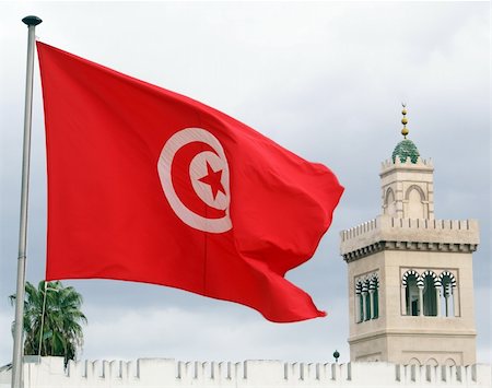 Red flag, clouds and minaret in Tunisia Fotografie stock - Microstock e Abbonamento, Codice: 400-05891769