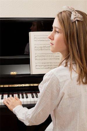 piano practice - Photo of a young girl playing the piano at home. Stock Photo - Budget Royalty-Free & Subscription, Code: 400-05892041