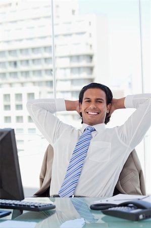 simsearch:6116-08915424,k - Portrait of a businessman relaxing in his office while looking at the camera Foto de stock - Super Valor sin royalties y Suscripción, Código: 400-05892347