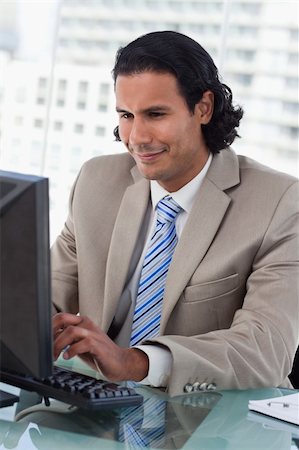 simsearch:400-04879813,k - Portrait of a businessman working with a monitor in his office Stock Photo - Budget Royalty-Free & Subscription, Code: 400-05892341