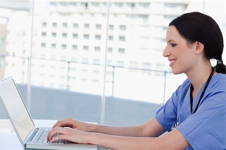 simsearch:400-04178933,k - Doctor using a laptop in her office Stock Photo - Budget Royalty-Free & Subscription, Code: 400-05892374
