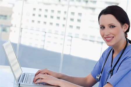 simsearch:400-04704005,k - Doctor using a notebook in her office Stock Photo - Budget Royalty-Free & Subscription, Code: 400-05892375