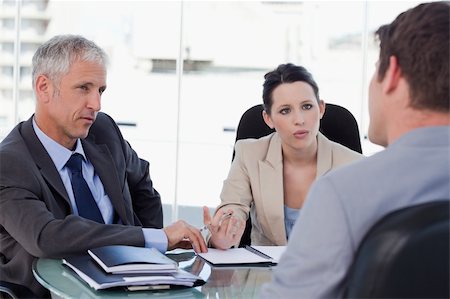 simsearch:400-04187120,k - Business team negotiating with a customer in a meeting room Stock Photo - Budget Royalty-Free & Subscription, Code: 400-05892373