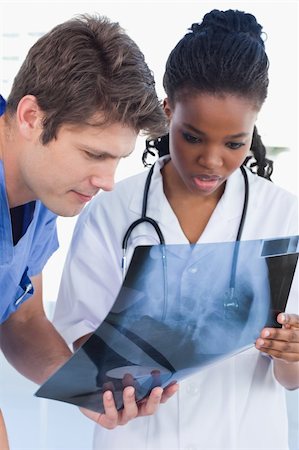Portrait of doctors looking at a of X-ray in an office Stock Photo - Budget Royalty-Free & Subscription, Code: 400-05892439