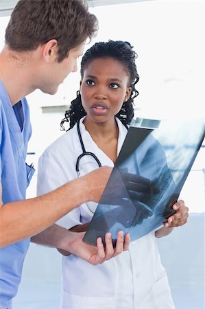 Portrait of young doctors looking at a of X-ray in an office Stock Photo - Budget Royalty-Free & Subscription, Code: 400-05892444