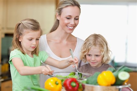 simsearch:400-04792006,k - Mother together with daughter and son preparing salad together Stock Photo - Budget Royalty-Free & Subscription, Code: 400-05893047