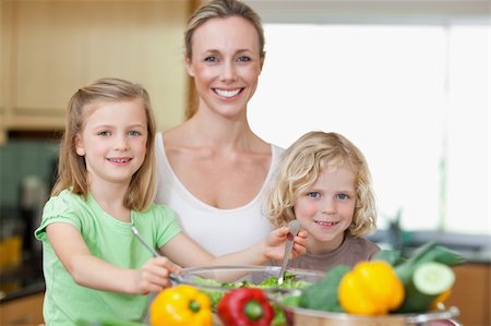 simsearch:400-04792006,k - Smiling woman together with her children preparing salad Stock Photo - Budget Royalty-Free & Subscription, Code: 400-05893049