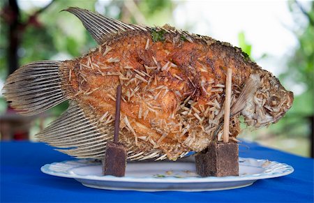 Fried fish on the table of a Vietnamese restaurant Stock Photo - Budget Royalty-Free & Subscription, Code: 400-05893595