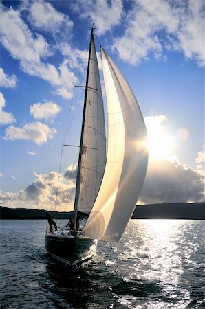 Sailing yacht in the action with sun back lit Stock Photo - Budget Royalty-Free & Subscription, Code: 400-05893664