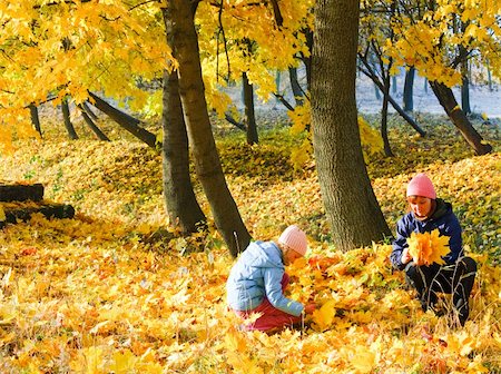 Happy family (mother with daughter) walking in golden maple autumn park Stock Photo - Budget Royalty-Free & Subscription, Code: 400-05904364