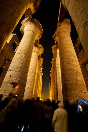 Columns in the ancient egyptian temple of Karnak at Luxor with hieroglyphic carvings lit up during the night sound and light show Stockbilder - Microstock & Abonnement, Bildnummer: 400-05904460