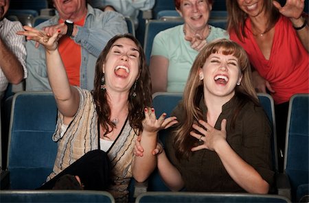 photo of theatre audience laughing - Young women laugh out loud in theater Stock Photo - Budget Royalty-Free & Subscription, Code: 400-05904534