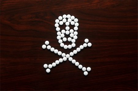 White pills formed into a skull on wooden surface Stock Photo - Budget Royalty-Free & Subscription, Code: 400-05905063