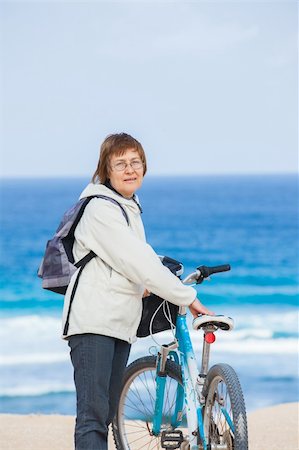 seniors bike riding on beach - A nice senior lady riding a bike on the beach. Lanzarote. Canaries Stock Photo - Budget Royalty-Free & Subscription, Code: 400-05905098