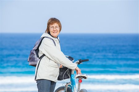 seniors bike riding on beach - A nice senior lady riding a bike on the beach. Lanzarote. Canaries Stock Photo - Budget Royalty-Free & Subscription, Code: 400-05905306