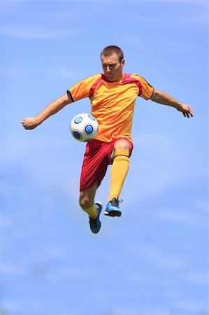 football flying - Soccer player kicking the ball while jumping. Stock Photo - Budget Royalty-Free & Subscription, Code: 400-05905586